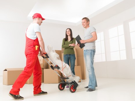 Mover carrying furniture while following safe handling procedures