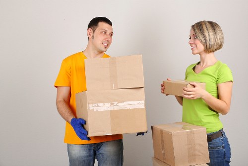 Local removal team loading household items into a van